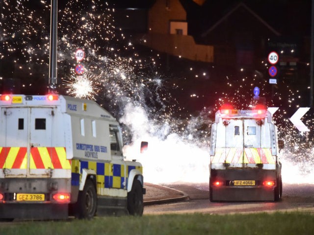 LARNE, NORTHERN IRELAND - APRIL 06: Police come under attack from fireworks and rocks as they unblock the main route into Larne town and harbour as Loyalists hold an anti Northern Ireland Protocol protest against the so called Irish Sea border on April 6, 2021 in Larne, Northern Ireland. (Photo …