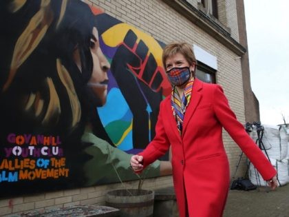 Scotland's First Minister and leader of the Scottish National Party (SNP), Nicola Sturgeon poses in front of a Black Lives Matters mural as she campaigns in Glasgow on April 8, 2021. (Photo by Andrew Milligan / POOL / AFP) (Photo by ANDREW MILLIGAN/POOL/AFP via Getty Images)