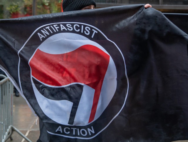 NEW YORK, NY - APRIL 11: People hold Antifa flags at Trump Tower to counter protest the &q