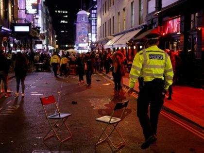 Police officers patrol the streets after a day where customers were able to drink at tables outside the pubs and bars in the Soho area of London, on April 12, 2021 after coronavirus restrictions were eased across the country in step two of the government's roadmap out of England's third …