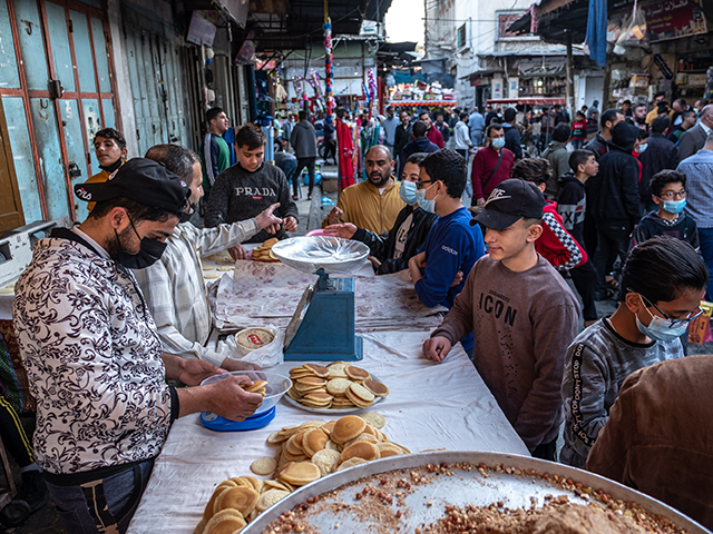 People buy food on the first day of the holy month of Ramadan in Al-Zawiya market in Old Gaza on April 13, 2021 in Gaza City, Gaza. Millions of Muslims around the world began observing the holy month of Ramadan amid the ongoing coronavirus pandemic. (Photo by Fatima Shbair/Getty Images)