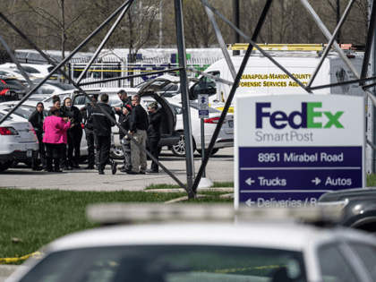 A group of crime scene investigators gather to speak in the parking lot of a FedEx SmartPo