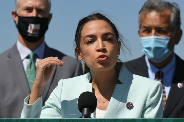 Representative Alexandria Ocasio-Cortez(D-NY) next to Senator Ed Markey(R), D-MA, speaks during a press conference to re-introduce the Green New Deal in front of the US Capitol in Washington, DC on April 20, 2021. (Photo by MANDEL NGAN / AFP) (Photo by MANDEL NGAN/AFP via Getty Images)