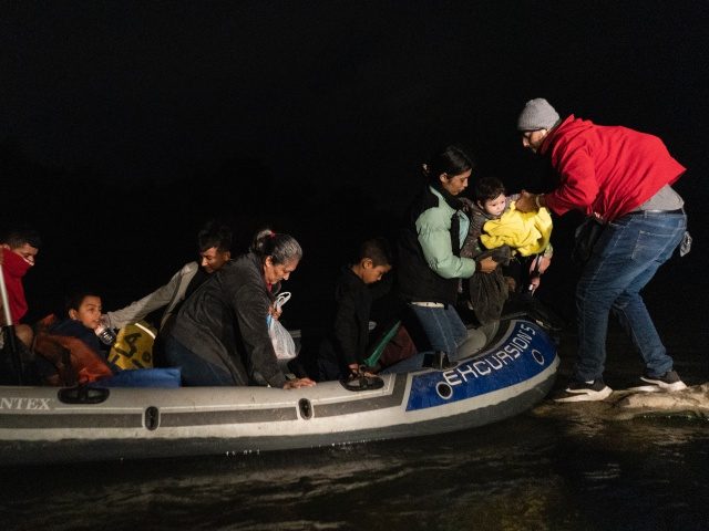 ROMA, TX - APRIL 23: Asylum-seeking migrants' families disembark from an inflatable raft after crossing the Rio Grande river into the United States from Mexico on April 23, 2021 in Roma, Texas. A surge of mostly Central American immigrants crossing into the United States, including record numbers of children, has …