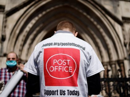 A supporter celebrates outside the Royal Courts of Justice in London, on April 23, 2021, following a court ruling clearing subpostmasters of convictions for theft and false accounting. - Dozens of former subpostmasters, who were convicted of theft, fraud and false accounting because of the Post Office's defective Horizon accounting …