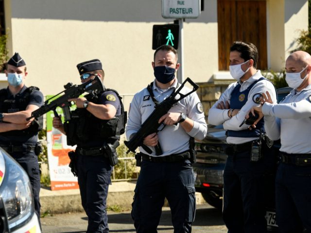 French police officials block off a street near a police station in Rambouillet, south-west of Paris, on April 23, 2021, after a woman was stabbed to death. - A female police employee was stabbed to death by a Tunisian man at a police station southwest of Paris on Friday, the …