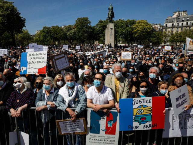 People hold placards reading "Justice for Sarah" (2R) and "I won't be the next Sarah Halimi" (L) as they gather to ask justice for late Sarah Halimi on Trocadero plaza in Paris on April 25, 2021. - Halimi, a 65-year-old Orthodox Jewish woman, died in 2017 after being pushed out …