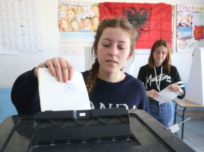 A woman casts her ballot at a voting station in the village of Paskuqan, near Tirana, during Albanias' Parliamentary elections on April 25, 2021. - Albania holds general elections with the centre-left sitting Prime Minister of the Socialist Party running for a third mandate, and facing a challenge from a …