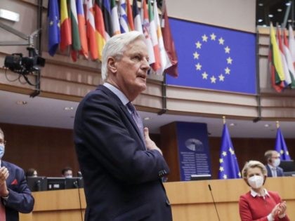 Head of the Task Force for Relations with the UK, Michel Barnier (C), flanked by European Commission President Ursula von der Leyen (R) gestures during the debate on EU-UK trade and cooperation agreement during the second day of a plenary session at the European Parliament in Brussels, on April 27, …