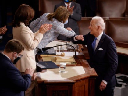 WASHINGTON, DC - APRIL 28: U.S. President Joe Biden elbow bumps Speaker of the House Nancy Pelosi as he greets her and Vice President Kamala Harris after concluding his address to a joint session of the U.S. Congress in the House chamber of the U.S. Capitol April 28, 2021 in …