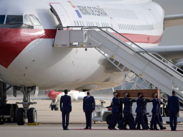 Spanish airforce personnel carry one of the three coffins with the bodies of Spanish journ