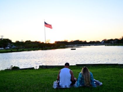 VARIOUS CITIES - SEPTEMBER 05: A couple watches the sunset on September 05, 2020 in Asbur