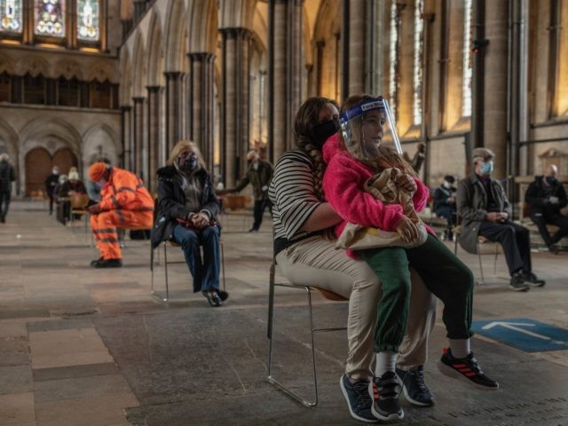 SALISBURY, ENGLAND - FEBRUARY 11: Mum Jade, waits with her daughter Lola after receiving her Covid-19 jab at a vaccination centre at Salisbury Cathedral on February 11, 2021 in Salisbury, England. Over 13 million people in the United Kingdom have had their first Covid-19 vaccination, including 90 percent of over-70s. …