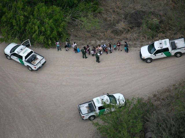 MCALLEN, TEXAS - MARCH 23: U.S. Border Patrol agents take asylum seekers into custody as seen from a Texas Department of Public Safety helicopter near the U.S.-Mexico Border on March 23, 2021 in McAllen, Texas. Texas DPS troopers are taking part in Operation Lone Star in supporting U.S. Border Patrol agents to "deny Mexican Cartels and other smugglers the ability to move drugs and people into Texas." (Photo by John Moore/Getty Images)