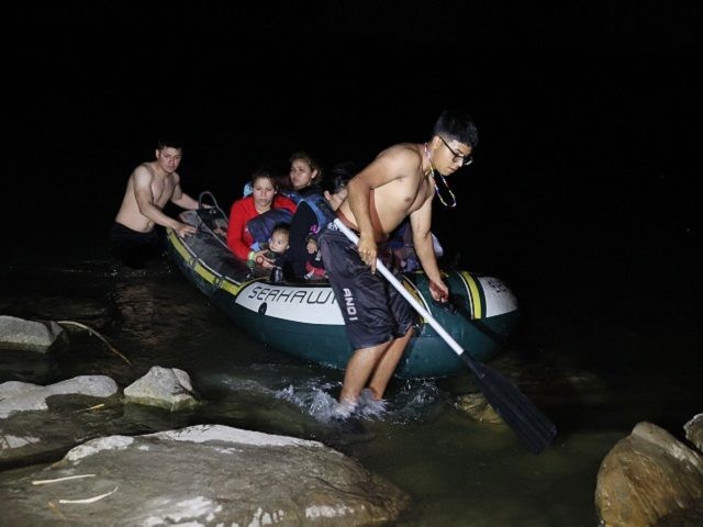 MISSION, TEXAS - MARCH 30: A group of migrants arrives in the U.S. after crossing the Rio Grande in a raft piloted by smugglers on March 30, 2021 in Roma, Texas. The group, made up of individuals from Honduras, turned themselves into the U.S. Border Patrol after crossing as they …