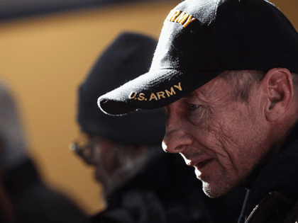 A homeless U.S. military veteran stands in line for free winter clothing at a "Stand Down"