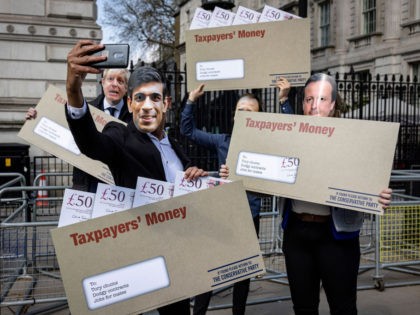 LONDON, ENGLAND - APRIL 21: Labour Party campaigners pose for a selfie outside Downing Street during a stunt in which they carried envelopes labelled "Taxpayer's Money" while dressed as Chancellor of the Exchequer Rishi Sunak, Prime Minister Boris Johnson, Health Secretary Matt Hancock, and former Prime Minister David Cameron, on …