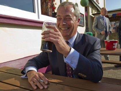 Leader of the UK Independence Party (UKIP) Nigel Farage, sits drinking a beer and smoking a cigarette as he speaks to members of the media outside a pub in Cliftonville, Margate, east of London, as he kicks off their "Say No To The EU" tour on September 7, 2015, during …