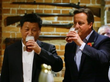 PRINCES RISBOROUGH, ENGLAND - OCTOBER 22: China's President Xi Jinping and Britain's Prime Minister David Cameron drink a pint of beer during a visit to the The Plough pub on October 22, 2015 in Princes Risborough, England. The President of the People's Republic of China, Mr Xi Jinping and his …