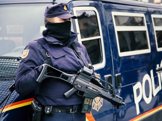 Madrid, Spain - February 2, 2015: Madrid policeman armed with machine gun and hand gun at