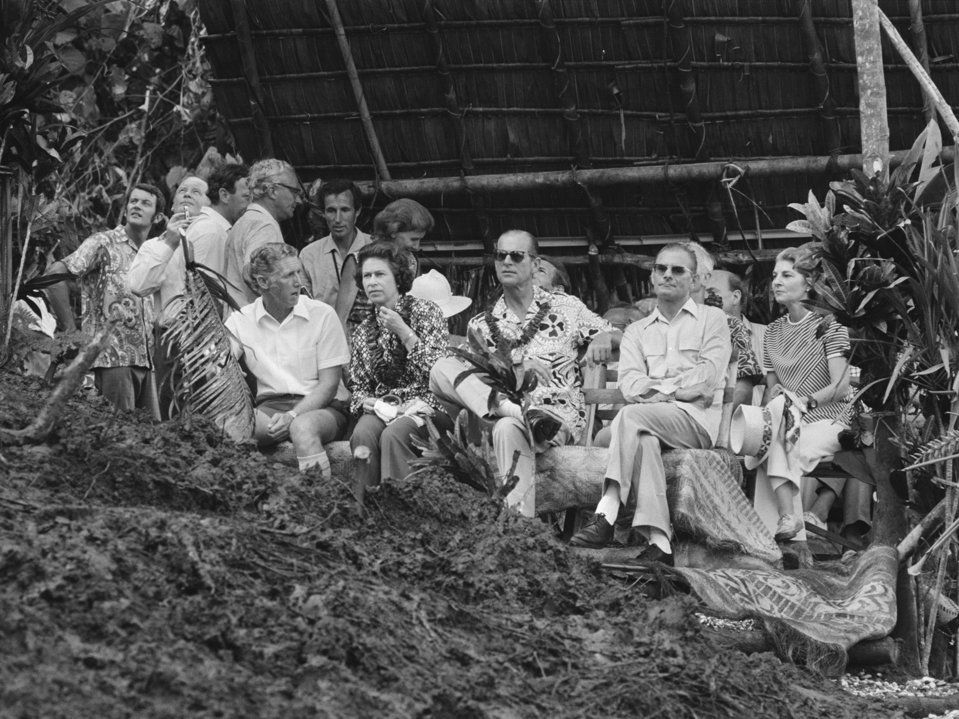 Queen Elizabeth and Prince Philip (centre) watching a display of land-diving from a bamboo tower, during their visit to Pentecost Island, Vanuatu, off the north-east coast of Australia, February 1974. Land diving is an initiation rite unique to the island, and is thought to be the origin of bungee jumping. (Photo by McCabe/Daily Express/Hulton Archive/Getty Images)