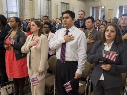 Candidates for US citizenship take the oath of allegiance to become US citizens during a Naturalization Ceremony for new US Citizens at the Department of Justice in Washington, DC, November 17, 2016. / AFP / SAUL LOEB (Photo credit should read SAUL LOEB/AFP via Getty Images)
