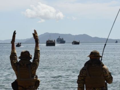 Members of Philippine navy special operations group (NAVSOG) signal to Philippine landing ships loaded with Philippine-US marines, and civilian volunteers as security and disaster responders during a simulation of a disaster drill as part of the annual joint Philippines-US military exercise in Casiguran town, Aurora province on May 15, 2017. …