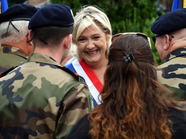 Far-right Front National (FN) party member of parliament Marine Le Pen speaks with military personnel as she attend the annual Bastille Day celebrations in Henin-Beaumont, northwestern France on July 14, 2017. / AFP PHOTO / FRANCOIS LO PRESTI (Photo credit should read FRANCOIS LO PRESTI/AFP via Getty Images)
