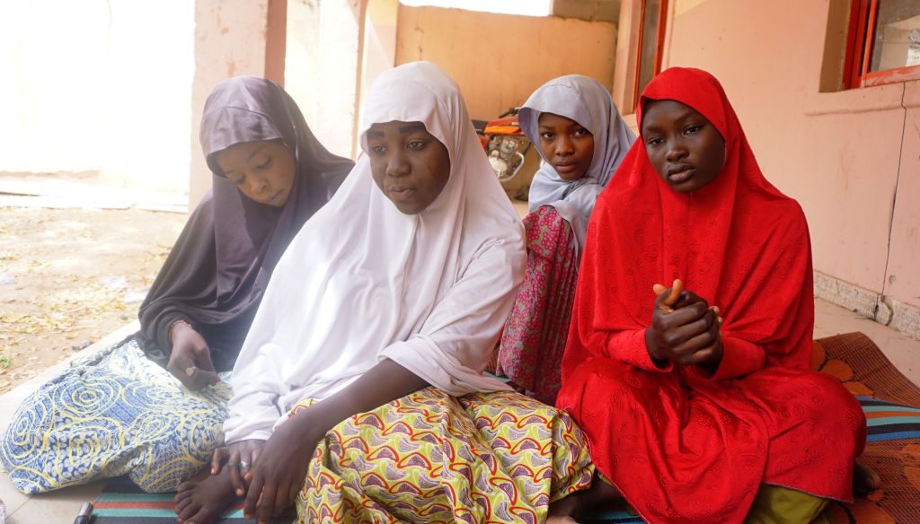 (From left) Fatima Abdu, 14, Zahra Bukar, 13, Fatima Bukar, 13 and Yagana Mustapha, 15, four schoolgirls of Government Girls Technical College, who escaped from Boko Haram attack, sit at home of schoolmate at Dapchi town in northern Nigerian on February 28, 2018. Nigeria's government on March 1 said it had set up a committee to establish how Boko Haram jihadists managed to kidnap 110 girls from their school in the country's remote northeast. Members of the militant Islamist group stormed the Government Girls Science and Technical College in Dapchi, Yobe state, on February 19, nearly four years after a similar mass abduction in Chibok, Borno state. / AFP PHOTO / AMINU ABUBAKAR (Photo credit should read AMINU ABUBAKAR/AFP via Getty Images)