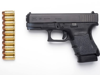 A Glock 30SF .45 Auto semi-automatic pistol with it's standard ten-round magazine installed, and ten rounds of hollow-point ammunition are seen in Alexandria, Va., Wednesday, Feb. 10, 2016. (AP Photo/Cliff Owen)