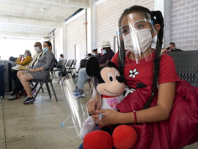 Genesis Cuellar, 8, a migrant from El Salvador, sits in a waiting area to be processed by