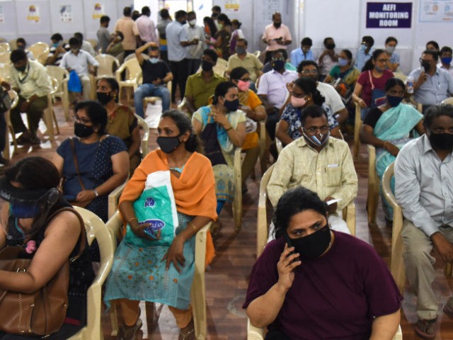 People wait in observation room to receive a dose of the Covishield, AstraZeneca-Oxford's Covid-19 coronavirus vaccine at a vaccination centre during a weekend lockdown imposed by the state government amidst rising Covid-19 coronavirus cases, in Mumbai on April 10, 2021. (Photo by Sujit Jaiswal / AFP) (Photo by SUJIT JAISWAL/AFP …