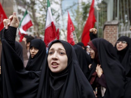 Iranian women chant slogans during an anti-US demonstration outside the former US embassy headquarters in the capital Tehran on May 9, 2018. - Iranians reacted with a mix of sadness, resignation and defiance on May 9 to US President Donald Trump's withdrawal from the nuclear deal, with sharp divisions among …