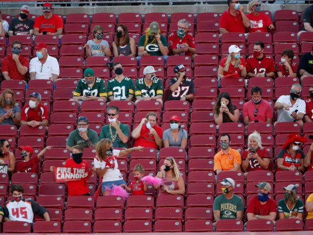 Fans social distance during an NFL football game between the Green Bay Packers and the Tam