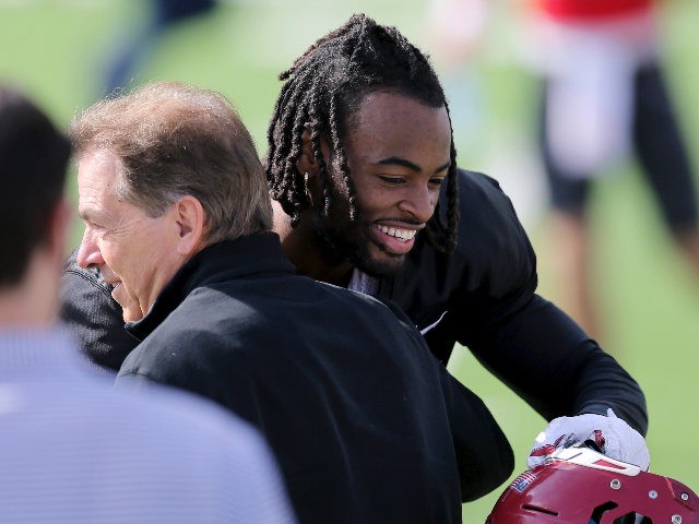 National Team running back Najee Harris of Alabama (22) hugs Alabama head coach Nick Saban