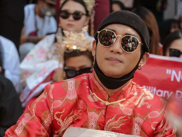Model, actor and singer Paing Takhon wears a traditional Chinese outfit while taking part in a demonstration against the military coup in front of the Chinese embassy in Yangon on February 11, 2021. (STR/AFP via Getty Images)