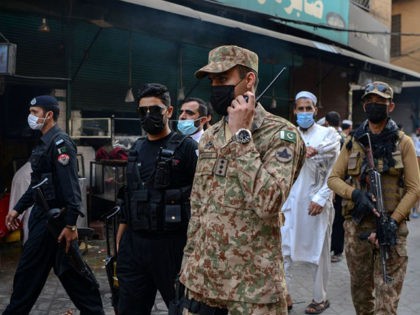 Army soldiers patrol in a market to implement new restrictions imposed as a preventive mea