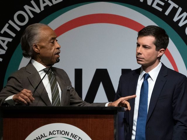 The Reverend Al Sharpton (L) asks a question of Democratic presidential candidate Pete Buttigieg during a gathering of the National Action Network April 4, 2019, in New York. - The National Action Network is a not-for-profit, civil rights organization founded by Sharpton. (Photo by Don EMMERT / AFP)