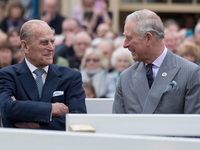 POUNDBURY, ENGLAND - OCTOBER 27: Britain's Prince Philip, Duke of Edinburgh (L) and Prince Charles, Prince of Wales (R) listen to speeches before a statue of the Queen Elizabeth, The Queen Mother was unveiled on October 27, 2016 in Poundbury, England. The Queen and The Duke of Edinburgh, accompanied by …