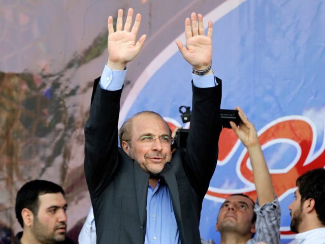 Iranian presidential candidate, Mohammad Bagher Qalibaf, who is also Tehran's mayor, waves to his supporters, during a campaign rally in Tehran, Iran, Wednesday, June 12, 2013. Qalibaf was boosted by a reputation as a steady hand for Iran's sanctions-wracked economy. Iran's reformist-backed presidential candidate Hasan Rouhani surged to a wide …