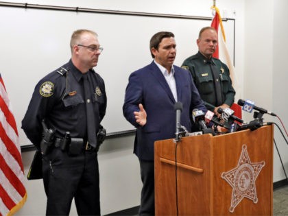 Florida Gov. Ron DeSantis, center, gestures as he speaks during a news conference alongside Sebring, Fla., police chief Karl Hoglund, left, and Highlands County sheriff Paul Blackman, right, Wednesday, Jan. 23, 2019, in Sebring, Fla., after authorities said five people were shot and killed at a SunTrust bank branch. (AP …