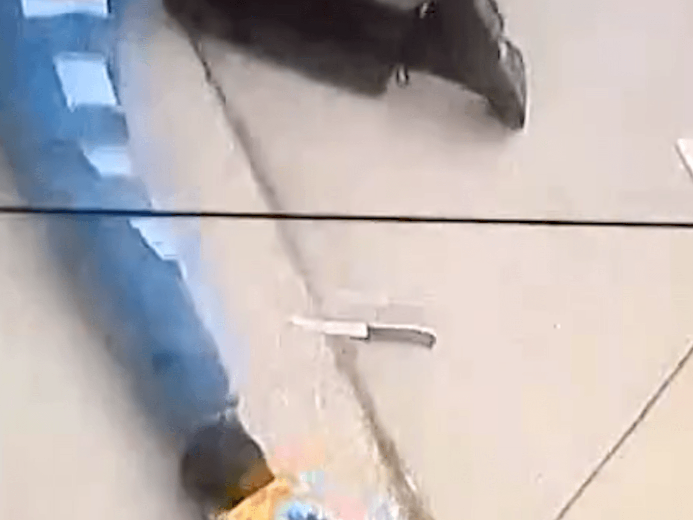 Screenshot from bodycam video showing the knife laying beside the teenage girl shot by police.