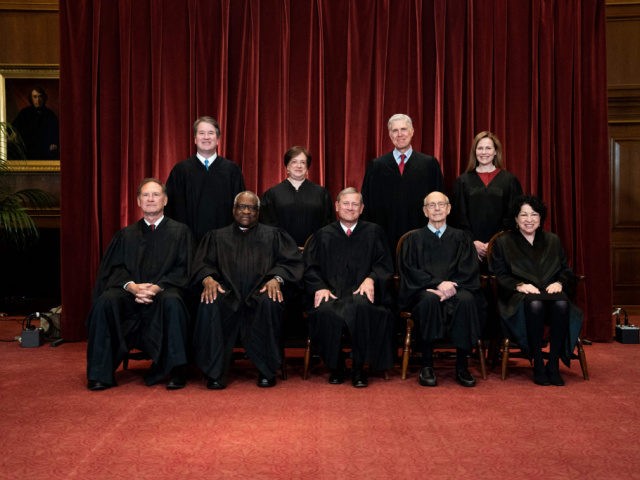 Seated from left: Associate Justice Samuel Alito, Associate Justice Clarence Thomas, Chief Justice John Roberts, Associate Justice Stephen Breyer and Associate Justice Sonia Sotomayor, standing from left: Associate Justice Brett Kavanaugh, Associate Justice Elena Kagan, Associate Justice Neil Gorsuch and Associate Justice Amy Coney Barrett pose during a group photo …