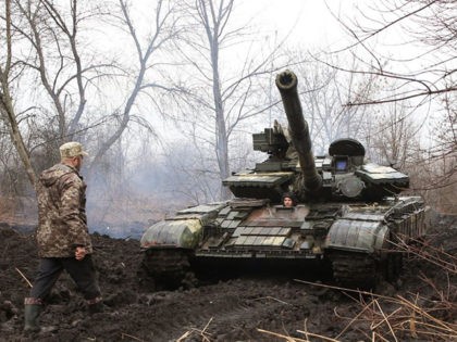 Ukrainian servicemen work on their tank close to the front line with Russian-backed separatists near Lysychansk, Lugansk region on April 7, 2021. - Ukrainian President Volodymyr Zelensky has urged NATO to speed up his country's membership into the alliance, saying it was the only way to end fighting with pro-Russia …