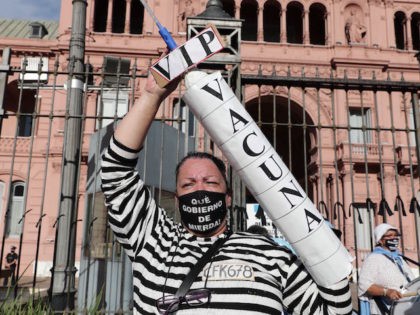 A woman protests against the government of President Alberto Fernandez, following a scandal over coronavirus vaccine queue-jumping that forced his health minister to resign, in front of the Casa Rosada presidencial palace in Buenos Aires, on February 27, 2021. - Argentina's President Alberto Fernandez said Tuesday that no crime had …