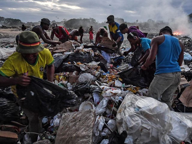 Venezuelan scavengers dig through trash at a landfill, in Pacaraima, Roraima State, Brazil, on the border with Venezuela, on February 28, 2019. (Photo by NELSON ALMEIDA / AFP) (Photo credit should read NELSON ALMEIDA/AFP via Getty Images)