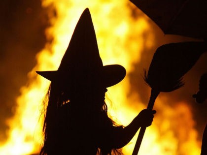 HUNTINGTOWN, MD - OCTOBER 25: Dressed as a witch, Leigh Kosega stands near a bonfire Octob