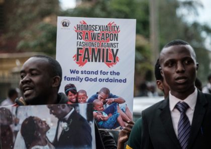 Christian members of the Sozo church of God hold anti-LGBTQ signs and sing against homosexuality after a verdict on scrapping laws criminalising homosexuality in front of the Milimani high court in Nairobi, Kenya, on May 24, 2019. - Kenya's high court, in a much-awaited verdict, refused to scrap laws criminalising …
