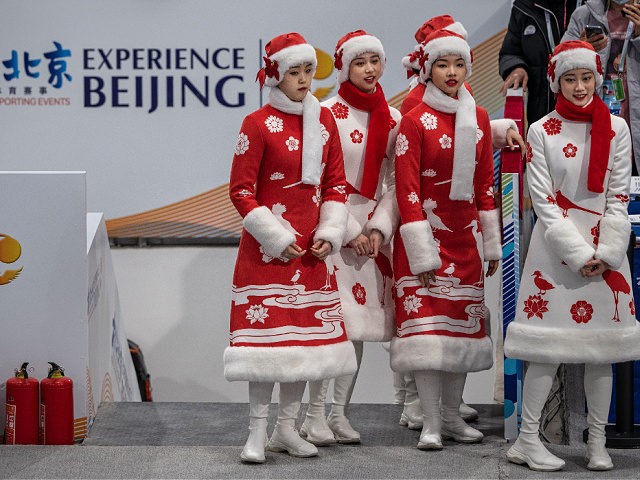 BEIJING, CHINA - APRIL 07: Chinese hostesses wait before the medal ceremony for the 3000 meter speed skating test event for the Beijing 2022 Winter Olympics at the National Speed Skating Oval on April 7, 2021 in Beijing, China. The events, which run from April 1-10, are the first tests …