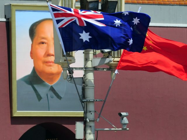 The national flags of Australia and China are displayed before a portrait of Mao Zedong facing Tiananmen Square, during a visit by Australia's Prime Minister Julia Gillard in Beijing on April 26, 2011. The trip is Gillard's first to China, Australia's top trading partner, and comes at a time when …